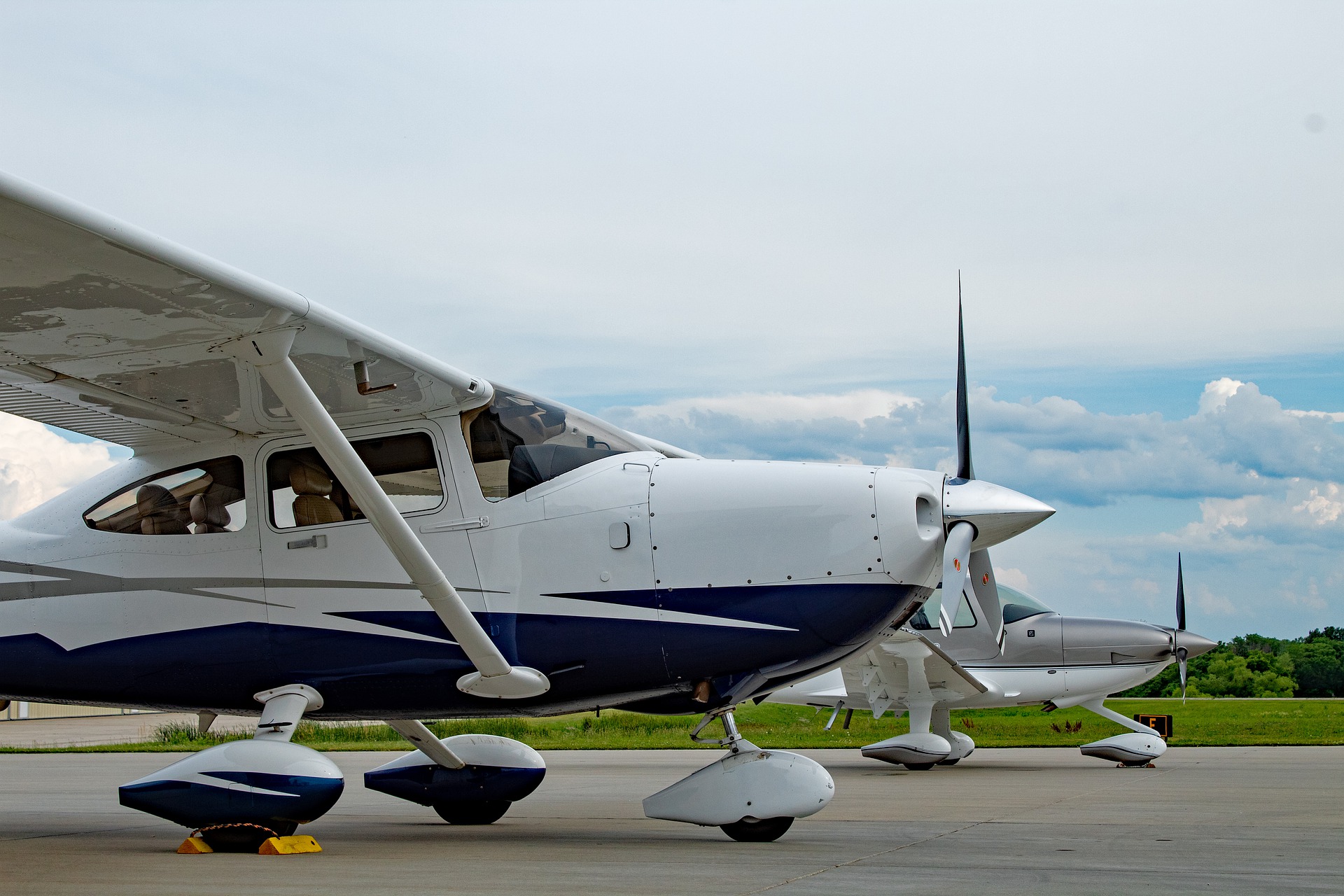 Two light aircraft parked on an airport apron